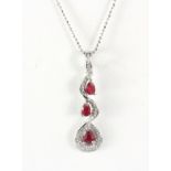 A matching 925 silver ruby and white stone set pendant and chain, L. 3.5cm.