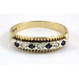 A 9ct yellow gold ring set with blue and white stones, (N).