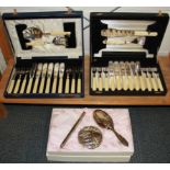 Two cased sets of cutlery and a dressing table set.