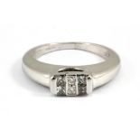 A 9ct white gold ring set with princess and brilliant cut diamonds, (K).