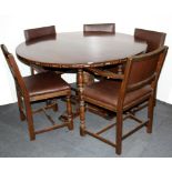 A circular oak pedestal dining table and five chairs, Dia. 130cm.