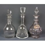 A Georgian cut glass decanter and two others, H. 32cm.