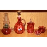 A group of five cranberry glass items.