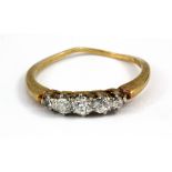 An 18ct yellow gold (stamped 18ct) graduated ring set with diamonds, (the two smaller stones