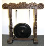 An Indonesian carved wooden frame and gong, W. 77cm H. 77cm.