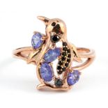 A 925 silver rose gold gilt penguin shaped ring set with tanzanites and black spinel, (S).