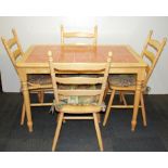 A tile topped kitchen table and four chairs.