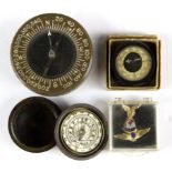 Two small compasses and a Bakelite cased sundial.