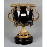An impressive bronze mounted black glazed porcelain urn, H. 37cm.