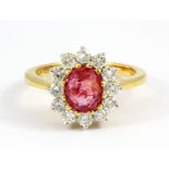 An 18ct yellow gold cluster ring set with a 2.19ct oval cut Burmese untreated ruby and brilliant cut