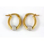 A pair of 9ct yellow and white gold hoop earrings.