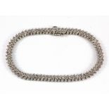 A 9ct white gold diamond set bracelet, L. 7.5cm.