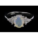 A 925 silver ring set with an oval cut opal and white stone set shoulders, (J.5).