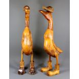 Two amusing carved hardwood ducks, H. 67cm.