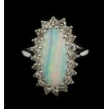 An 18ct white gold (worn stamp 18ct) cluster ring set with a cabochon cut opal and brilliant cut