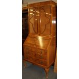 A 1930's satin walnut veneered bureau bookcase, W. 77cm H. 194cm.