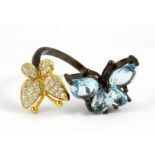 A 925 silver butterfly shaped adjustable ring set with blue topaz.