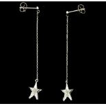 A pair of 18ct white gold (stamped 750) diamond set star drop earrings, L. 5cm.