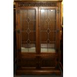 A carved oak and leaded glass display cabinet, W. 88cm H. 156cm.