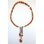 A silver and amber necklace.