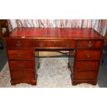 A leather topped mahogany desk, W. 136cm H. 79cm.