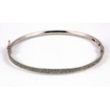 A 9ct white gold bangle, L. 6.5cm W. 4.2g.