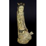 An early 20th Century Chinese carved antler figure of a goddess standing on a dragon, H. 16cm.