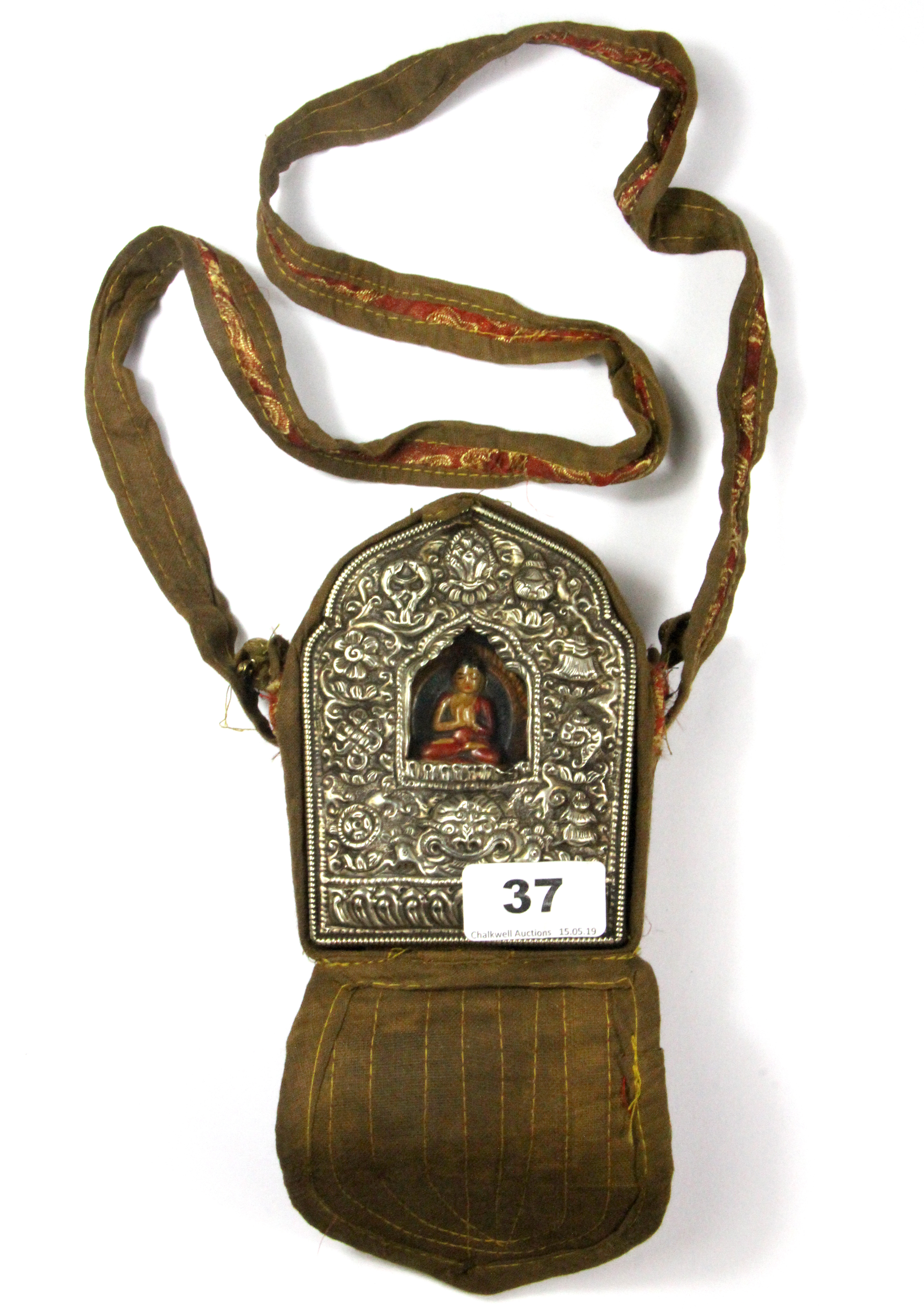 A Tibetan copper and hammered white metal ga'u (portable shrine) inset with a painted clay figure of