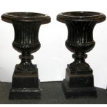 A pair of cast iron planters, Dia. 29cm H. 50cm.