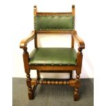 An upholstered oak armchair.