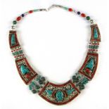 A Tibetan white metal necklace decorated with coral and turquoise.