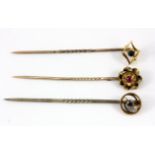 Two 15ct yellow gold stick pins and a further 9ct yellow gold stick pin.