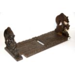 A 19th Century carved Black Forest bear bookrack, closed L. 39cm H. 17cm.