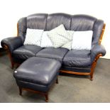 A vintage blue leather three seater settee and footstool.