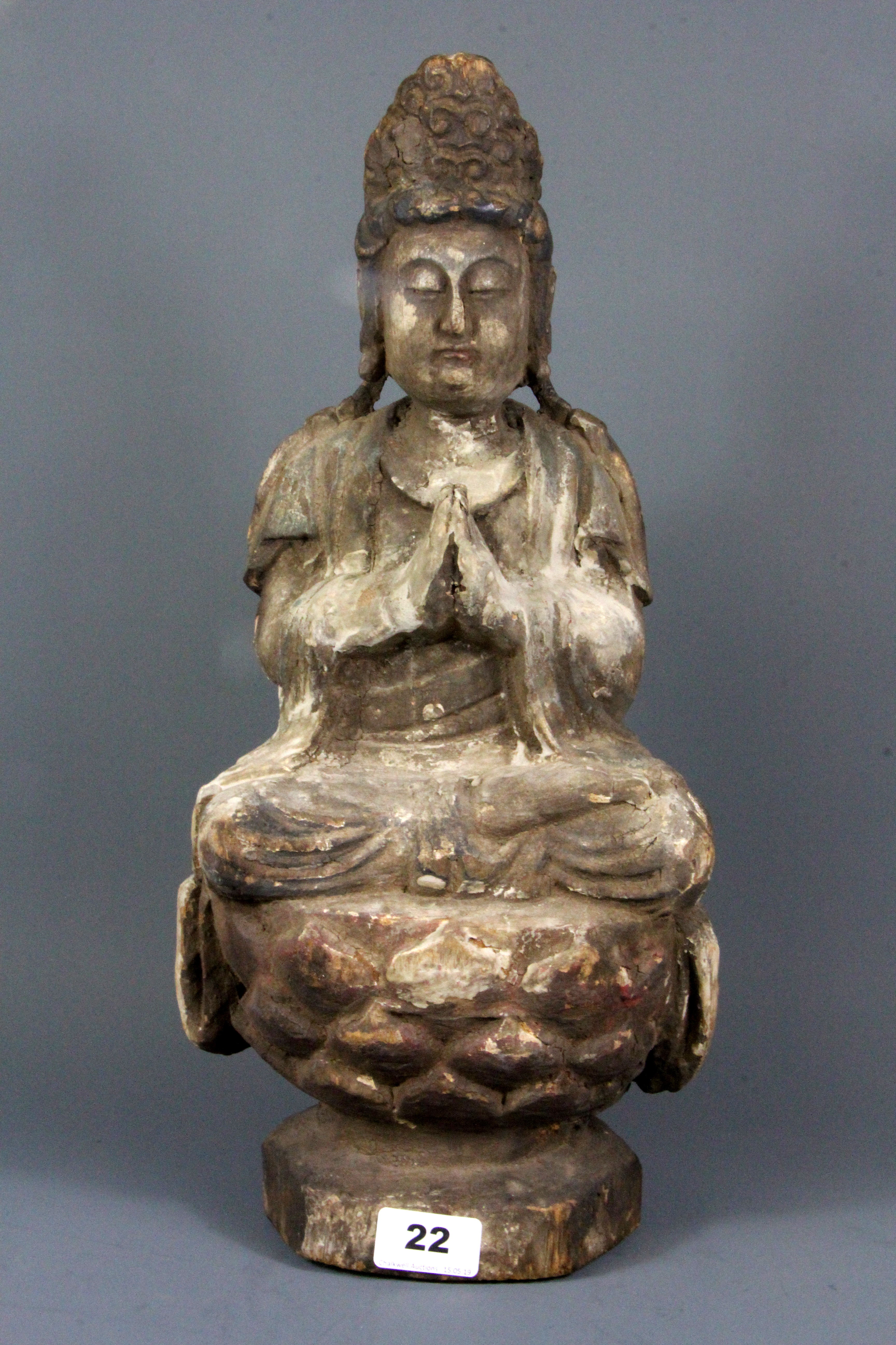 A Chinese carved wooden figure of the goddess Guanyin with remnants of gesso and paint, H. 45cm.