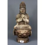 A Chinese carved wooden figure of the goddess Guanyin with remnants of gesso and paint, H. 45cm.