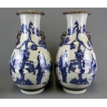A pair of Chinese crackle glazed and hand painted porcelain vases with relief decoration of Lohan,