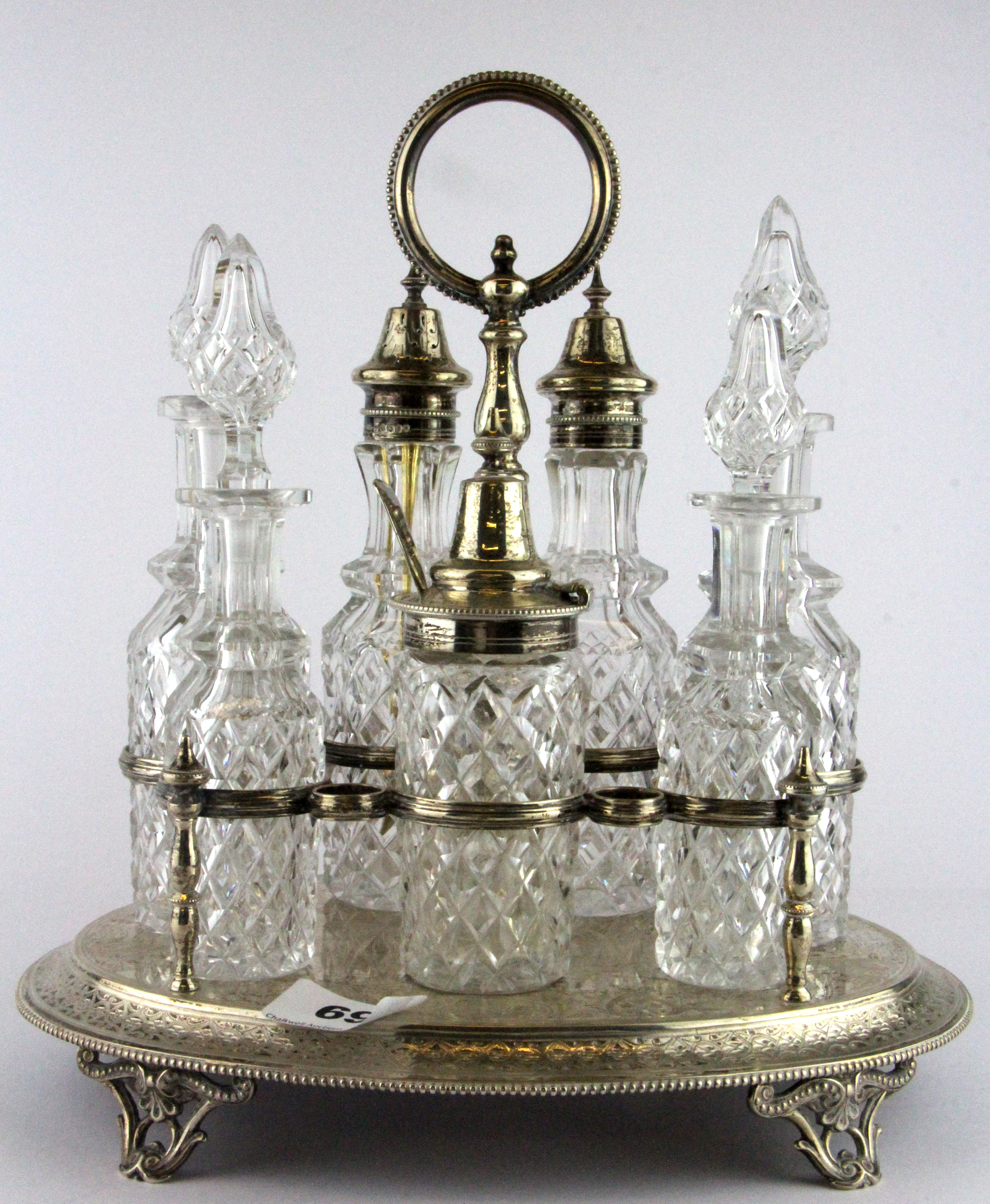 A superb hallmarked silver and cut glass seven bottle Victorian cruet set, W. 27cm H. 28cm. (In