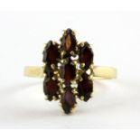 An 18ct yellow gold (stamped 750) ring set with marquise cut garnets.