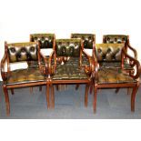 A set of six mahogany leather covered armchairs.