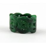 A Chinese carved green jade ring, W. 1.5cm. Internal Dia. 1.9cm.