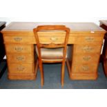 A 1920's leather topped light oak nine drawer desk with balloon back chair , desk size 137cm x 56
