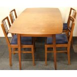 A 1970's extending teak dining table together with four chairs, table size 138 x 79cm.