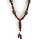 A Tibetan onyx and dzi bead necklace of prayer beads.