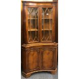 An unusual concave design maple veneered corner cabinet, W. 92cm.