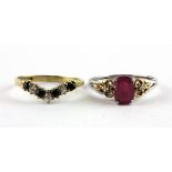 A 9ct yellow gold and 925 silver ring set with an oval cut ruby and diamond set shoulders, and a