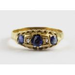 An 18ct yellow gold ring set with cornflower sapphires and diamonds, (M.5).