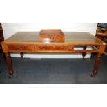 A large leather topped oak and burr walnut veneered desk with reeded legs, W. 182 x 92cm H. 78cm.