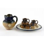 A Royal Doulton miniature stoneware jug with a 19th Century tin glazed plate and a group of