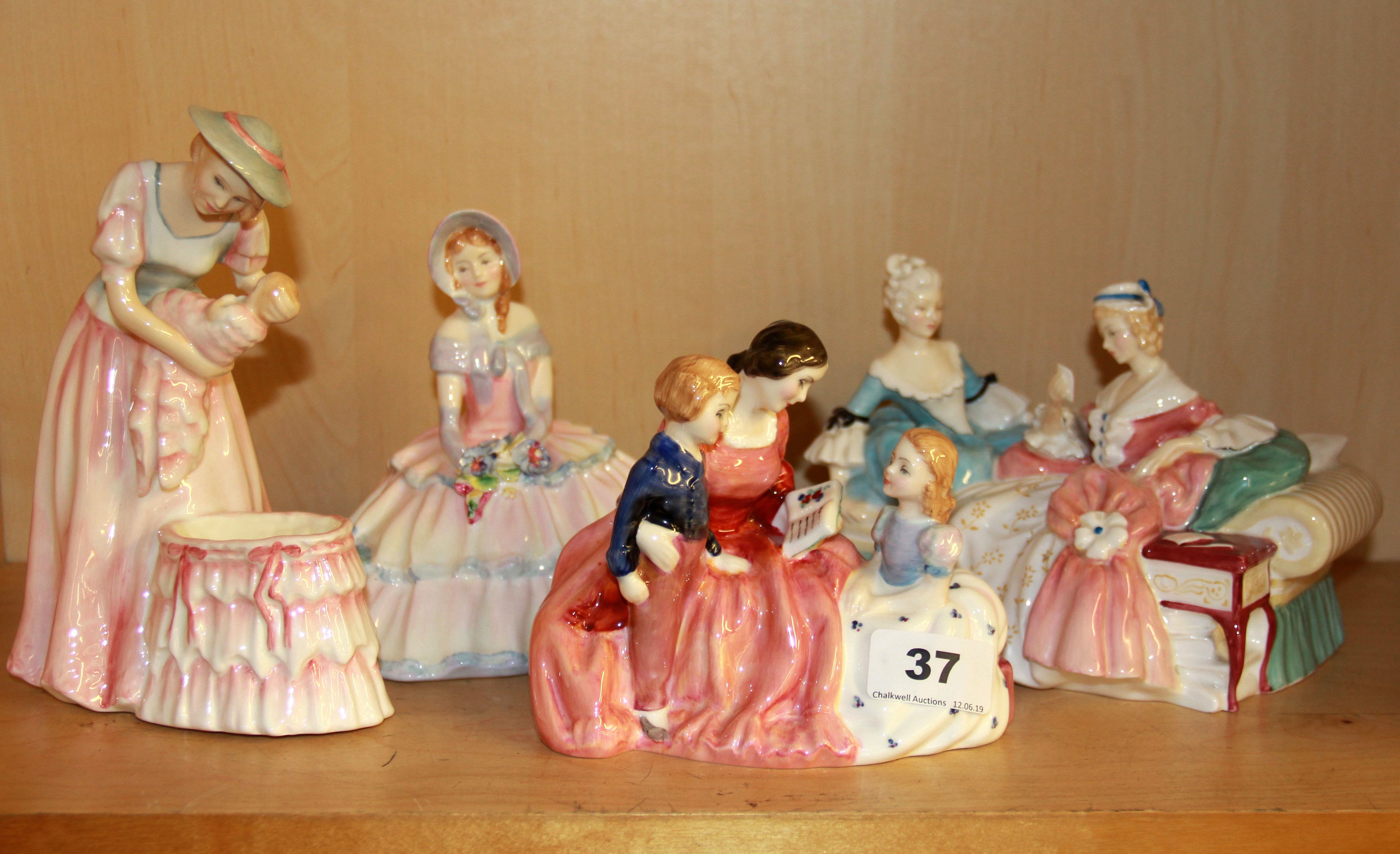 Four Royal Doulton porcelain figurines including 'The Bedtime Story' HN 2059, 'The Love Letter' HN